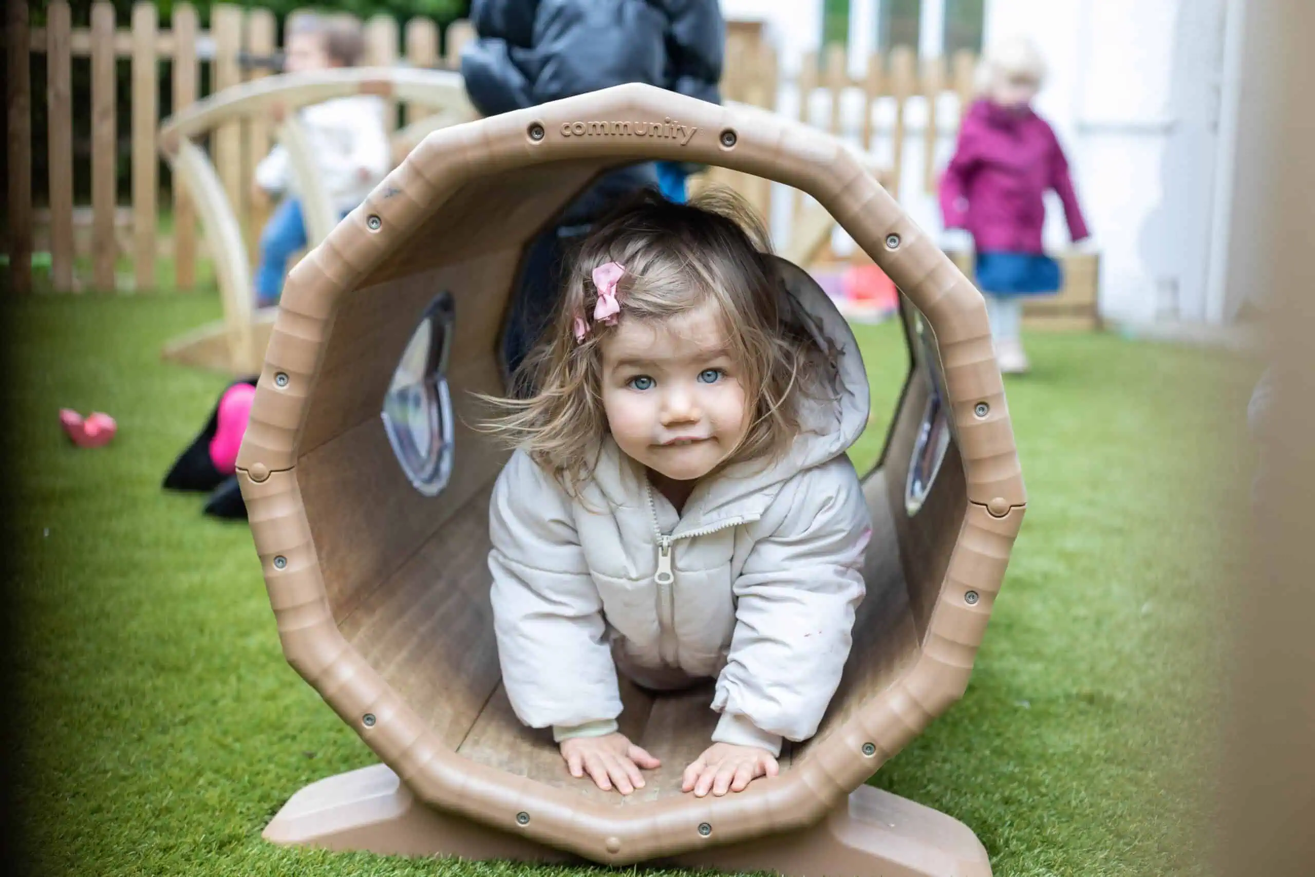 Toddler Playing in Outdoor Play Tunnel Monkey Puzzle Sunbury Toddlers Room